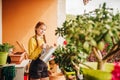 Adorable little girl watering plants on the balcony Royalty Free Stock Photo