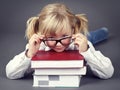 Adorable little girl wearing glasses and holding books Royalty Free Stock Photo