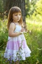 Adorable little girl in white dress in the forest. Forest Nymph. Sunny day