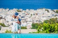 Adorable little girl and young mother in outdoor swimming pool background Mykonos town on Cyclades, Greece Royalty Free Stock Photo