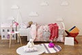 Adorable little girls bed room interior with toys, doll house and reading books. Royalty Free Stock Photo