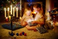 Adorable little girls opening a magical Christmas gift Royalty Free Stock Photo