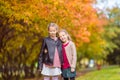 Little adorable girls at warm day in autumn park outdoors Royalty Free Stock Photo