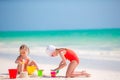 Adorable little girls during summer vacation. Kids playing with beach toys on the white beach Royalty Free Stock Photo