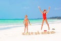 Adorable little girls during summer vacation. Kids playing with beach toys on the white beach Royalty Free Stock Photo