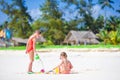 Adorable little girls during summer vacation. Kids playing with beach toys on the white beach Royalty Free Stock Photo