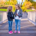 Adorable little girls at warm autumn day outdoors Royalty Free Stock Photo