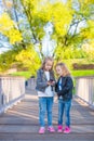 Adorable little girls at warm autumn day outdoors Royalty Free Stock Photo