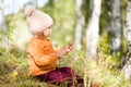 Adorable little grl in the autumn forest, sunny day. Royalty Free Stock Photo