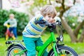 Adorable little kid boy driving his first bike or laufrad Royalty Free Stock Photo