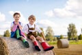 Adorable little kid boy and girl in traditional Bavarian costumes in wheat field on hay stack Royalty Free Stock Photo