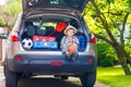 Little kid boy sitting in car trunk just before leaving for vaca Royalty Free Stock Photo