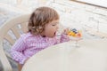 Little girl eating fruit salad. Royalty Free Stock Photo