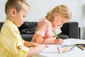 adorable little kids drawing with colored pencils Royalty Free Stock Photo