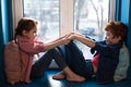 adorable little kids holding hands and smiling each other while sitting Royalty Free Stock Photo