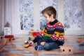 Adorable little preschool boy, playing with wooden trains and ra Royalty Free Stock Photo