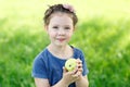 Adorable little preschool kid girl eating green apple on organic farm Royalty Free Stock Photo