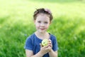 Adorable little preschool kid girl eating green apple on organic farm Royalty Free Stock Photo