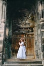 Adorable little redhead armenian christian girl praying in front of armenian ancient monastery Royalty Free Stock Photo