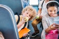 adorable little schoolboy eating apple while riding on school bus Royalty Free Stock Photo