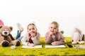 adorable little sisters drawing with color pencils together on floor