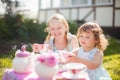 Two sisters playing tea party outdoors