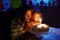 Adorable little toddler girl celebrating second birthday. Baby child daughter and young mother blowing candles on cake Royalty Free Stock Photo