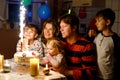 Adorable little toddler girl celebrating second birthday. Baby child, two kids boys brothers, mother and father together