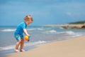 Adorable little toddler girl playing on sand beach Royalty Free Stock Photo