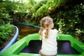 Adorable little toddler girl riding on boat carousel in amusement park. Happy healthy baby child having fun outdoors on Royalty Free Stock Photo