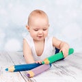 Adorable little toddler playing with big crayons Royalty Free Stock Photo