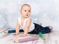 Adorable little toddler playing with big crayons Royalty Free Stock Photo