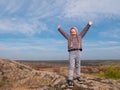 Adorable little traveler girl raising hands Child climbing on mountain summit spending time on nature walking having fun Royalty Free Stock Photo