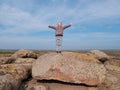 Adorable little traveler girl raising hands Child climbing on mountain summit spending time on nature walking having fun Royalty Free Stock Photo