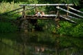 Adorable Little Twin Brothers Sitting on the Edge of Wooden Bridge and Fishing on Beautiful Lake