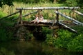 Adorable Little Twin Brothers Sitting on the Edge of Wooden Bridge and Fishing on Beautiful Lake Royalty Free Stock Photo