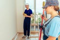 Smiling couple painting wall at home in yellow color Royalty Free Stock Photo