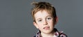 Adorable mischievous young kid with freckles and messy red hair