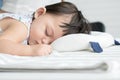 Adorable mixed race, Caucasian and Asian, little baby girl is sleeping on pillow at bedroom at home. Close up baby face shot. Royalty Free Stock Photo