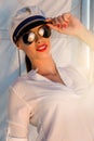 Adorable model wearing sea admirals hat and top at sunset.