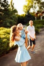 Adorable mom hold cute daughter in loving arms, smiling, hugging, lovely parents with little baby girl walking at the Royalty Free Stock Photo