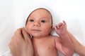 Adorable 2 months old little baby boy on towel after bath in his mother`s hands Royalty Free Stock Photo
