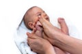 Adorable 2 months old little baby boy on towel after bath holding his mother`s hands Royalty Free Stock Photo