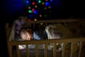 Adorable newborn baby boy, sleeping in crib at night