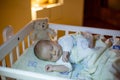 Adorable newborn baby boy, sleeping in crib at night Royalty Free Stock Photo