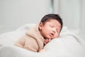 Adorable newborn baby peacefully sleeping on a white blanket. Royalty Free Stock Photo