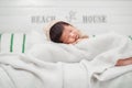Adorable newborn baby peacefully sleeping on a white blanket. Royalty Free Stock Photo