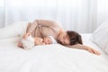 Adorable newborn baby sleeping on bed in mother arm nursing, young Asian beautiful mother lying down hold hug  infant 0-1 month Royalty Free Stock Photo