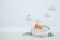 Adorable newborn child wearing bunny ears hat in baby nest indoors