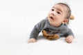 Adorable newborn kid during tummy time smiling happily at home.Portrait of cute smiling happy asian baby boy crawling on bed on Royalty Free Stock Photo